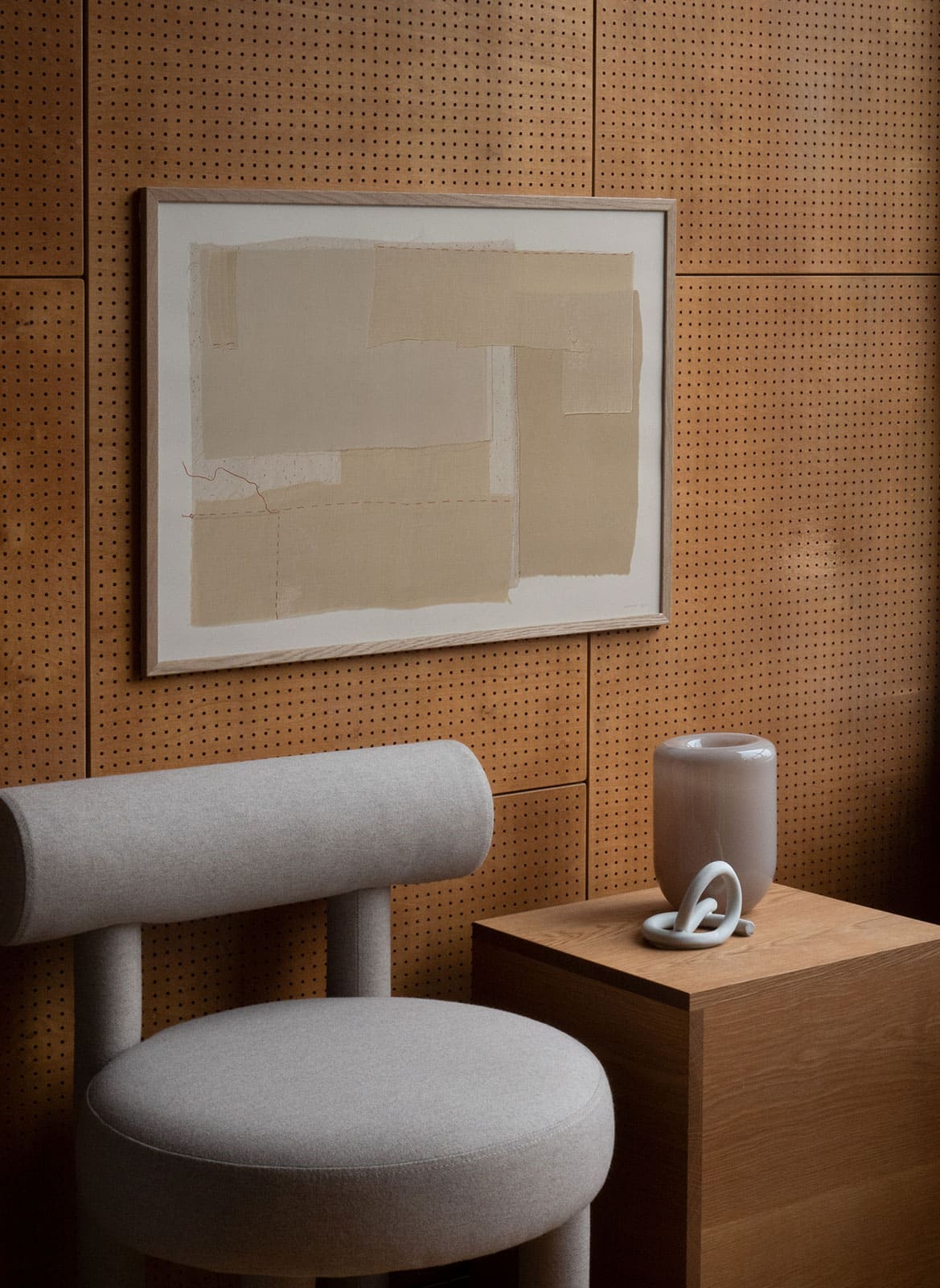 Framed beige poster hanging in a wooden living room by atelier cph