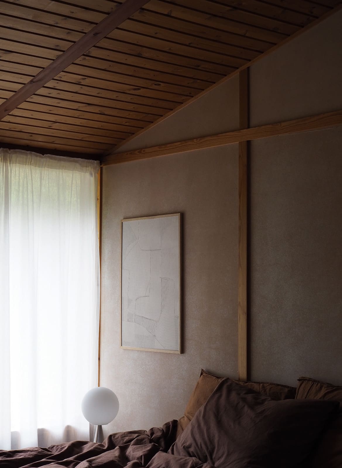 Framed minimalistic poster hanging in a bed room by Atelier Cph