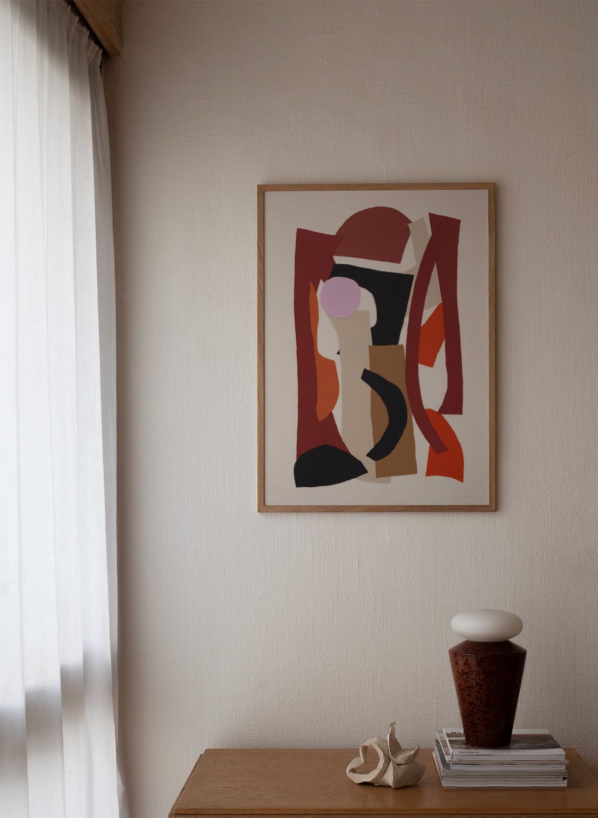  Framed colorful poster hanging in a living room by Atelier Cph