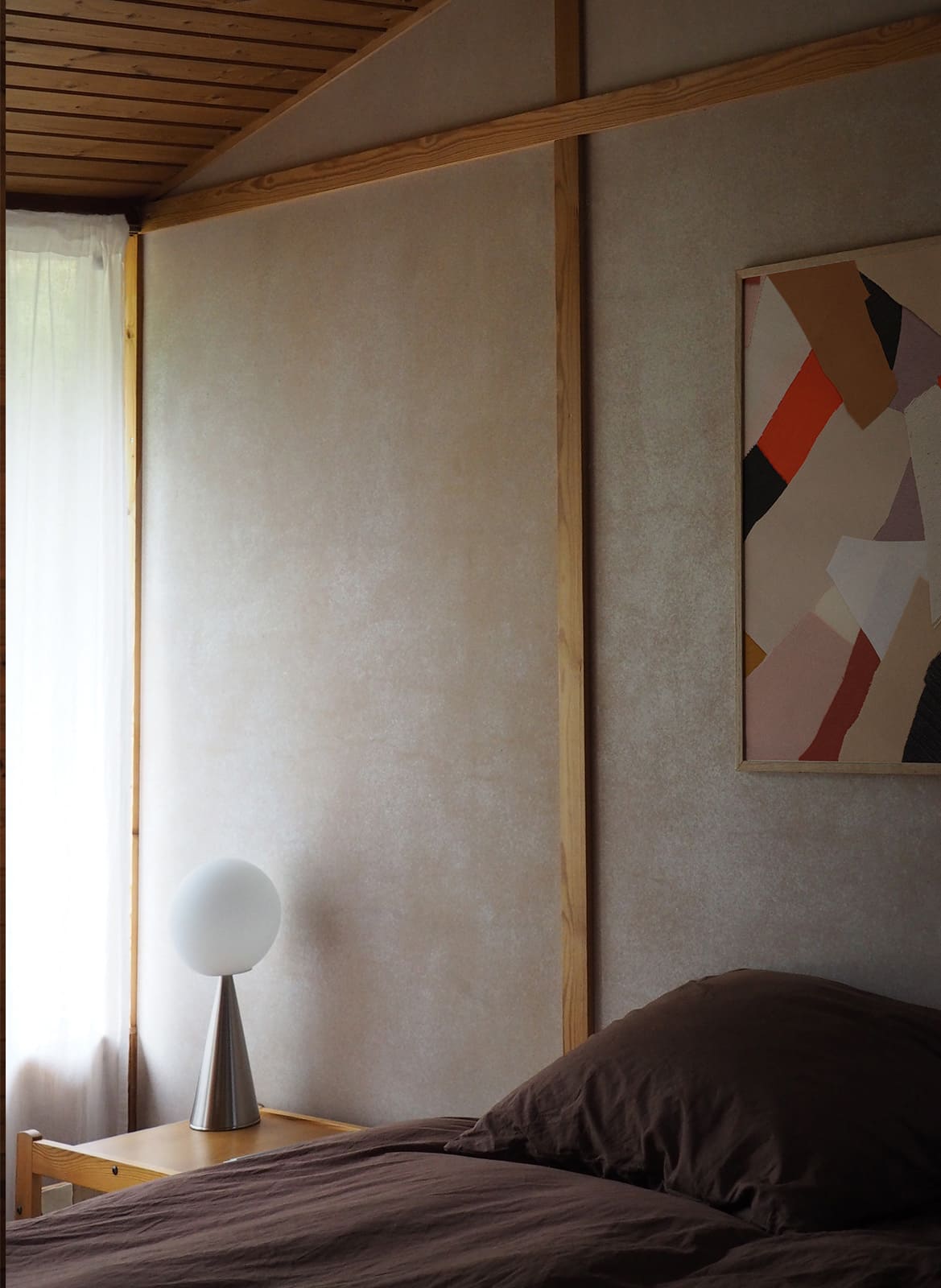  Framed colorful poster hanging above a bed by Atelier Cph