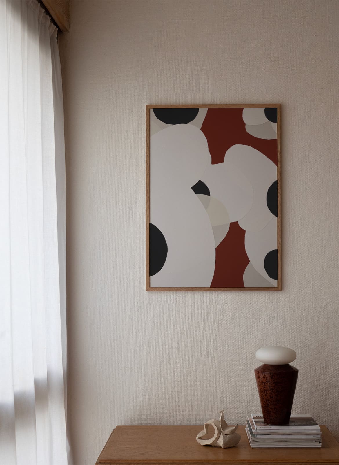 Framed colorful poster hanging in a living room by Atelier Cph