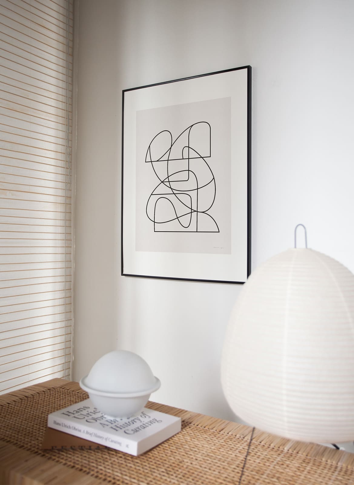 Framed minimalistic poster hanging in a living room by Atelier Cph
