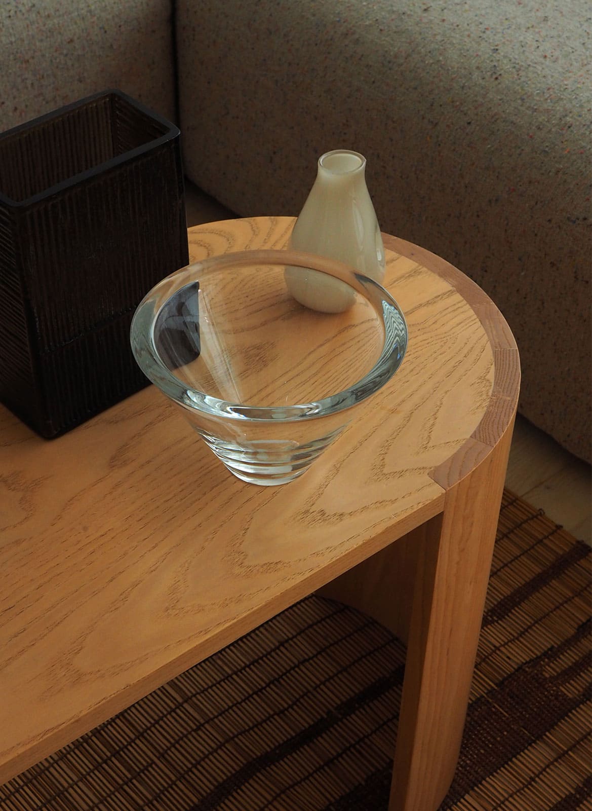 Simple glass bowl made by artist Hanne Dreutler standing on a wooden table