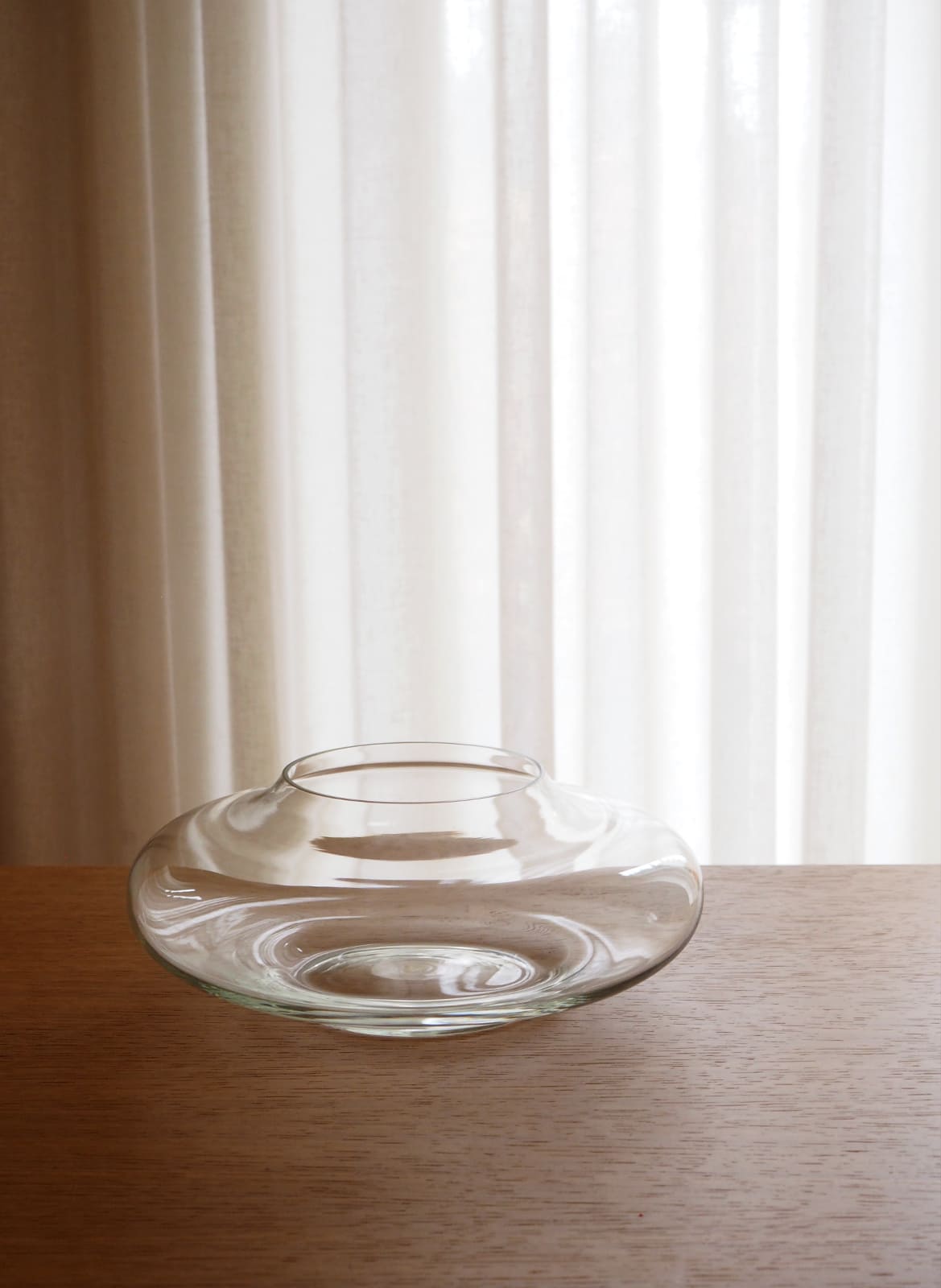 glass bowl standing on a wooden table