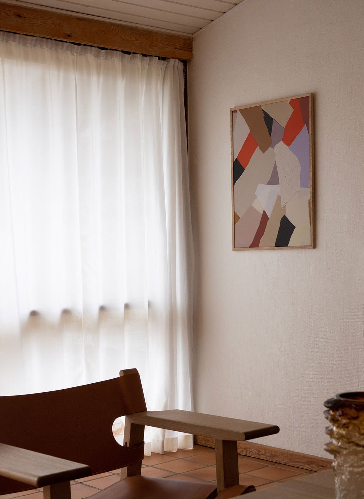 Framed colourful poster hanging in a living room by Atelier Cph